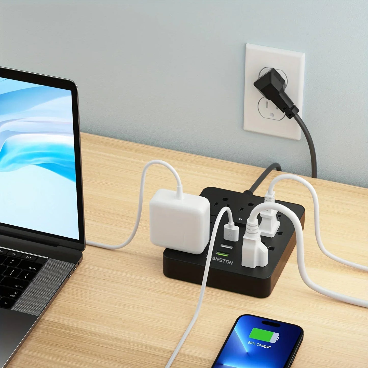TRANSTON 9 Outlet Power Strip with 3 USB Ports and 5ft Extension Cord in use on a desk with laptop and phone.