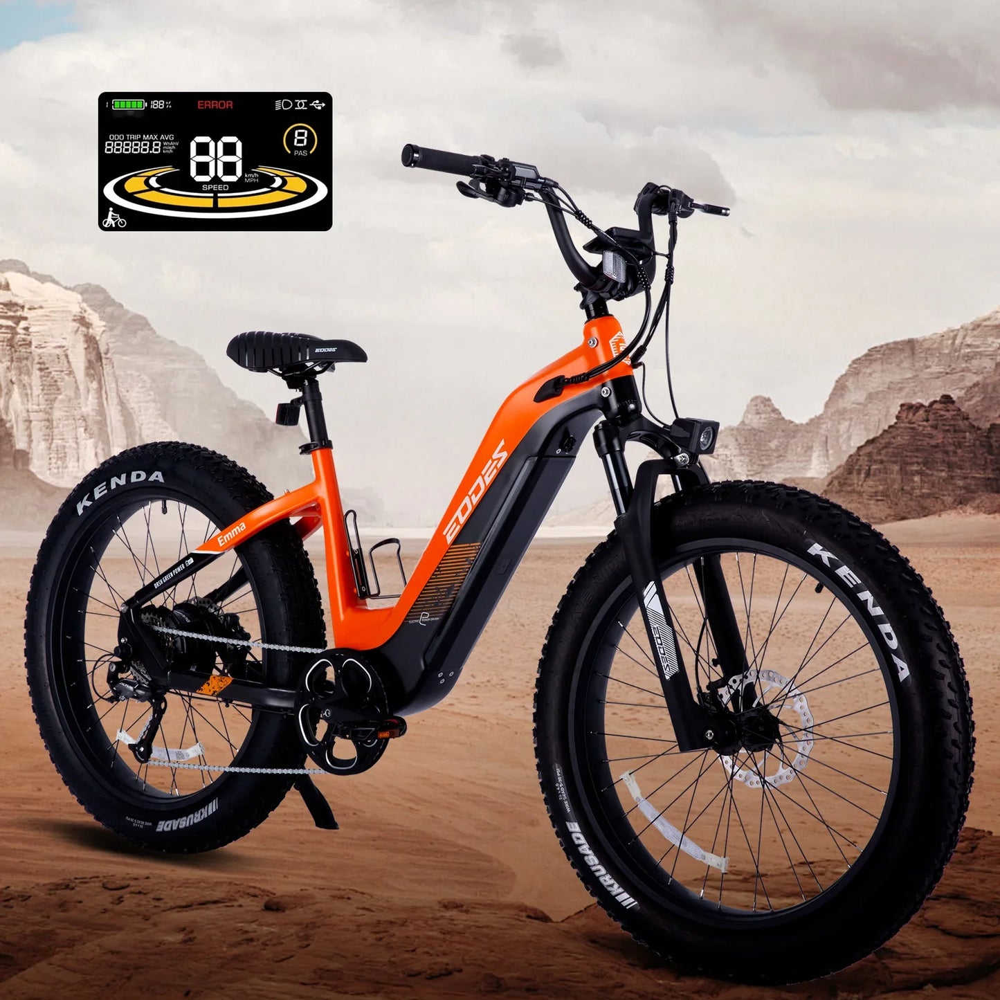 Off-road electric bike with 26-inch fat tires, orange color, and LCD display in desert landscape.
