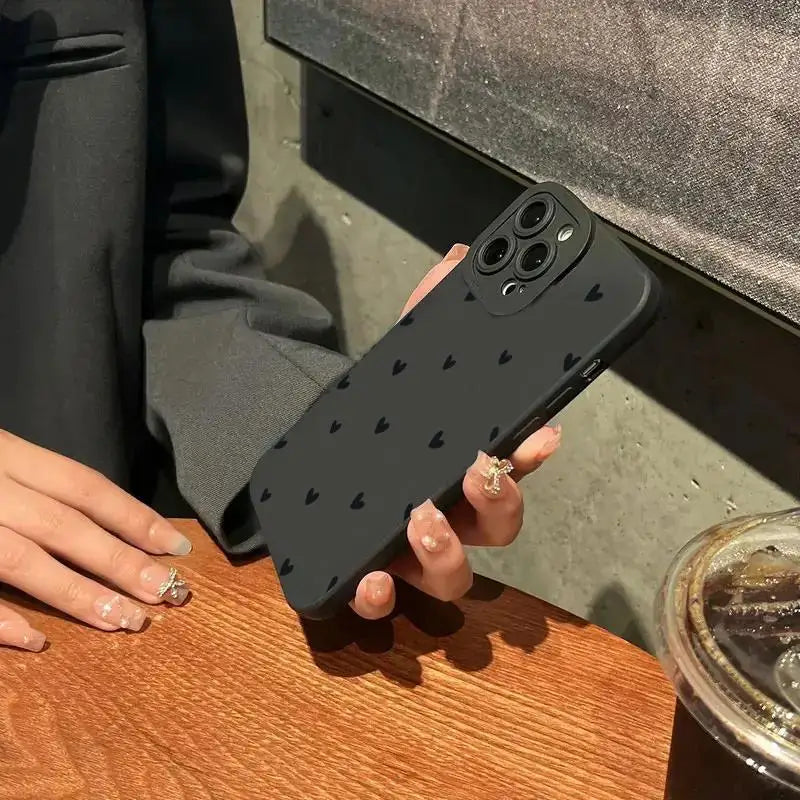 Black Love Heart shockproof silicone phone case for iPhone models, featuring a soft black cover with heart design.