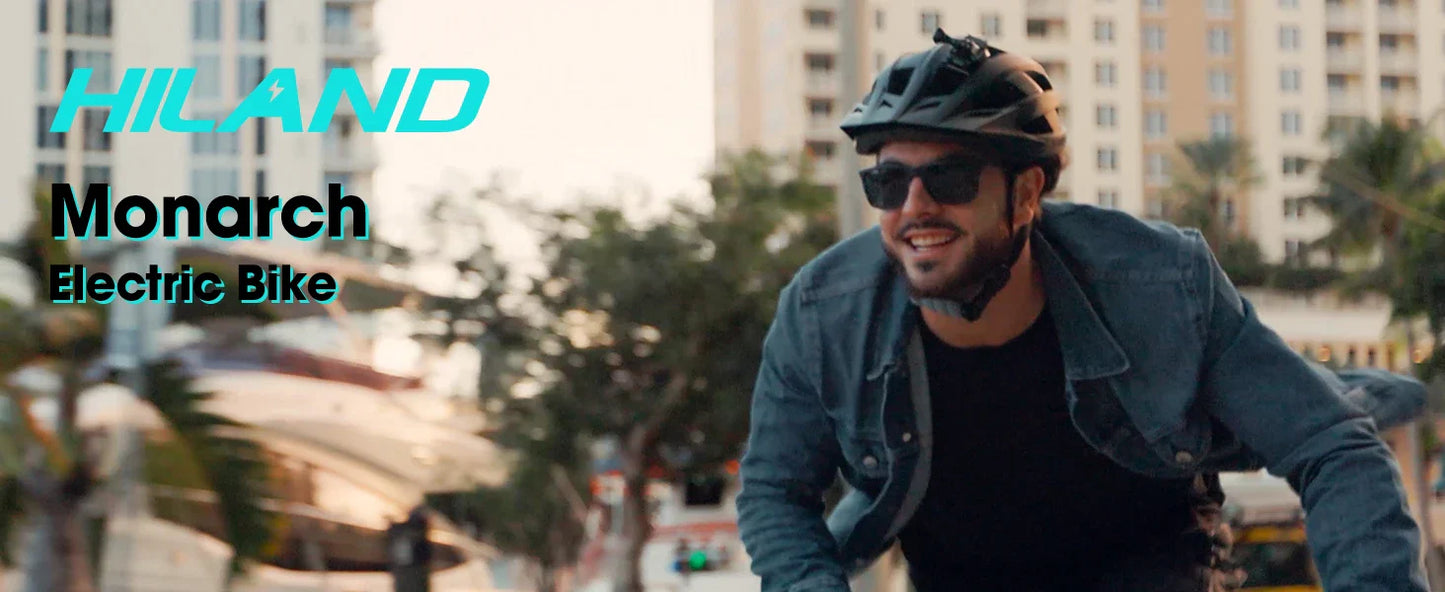 Man riding a HILAND Monarch Electric Bike in an urban setting, wearing sunglasses and a helmet.