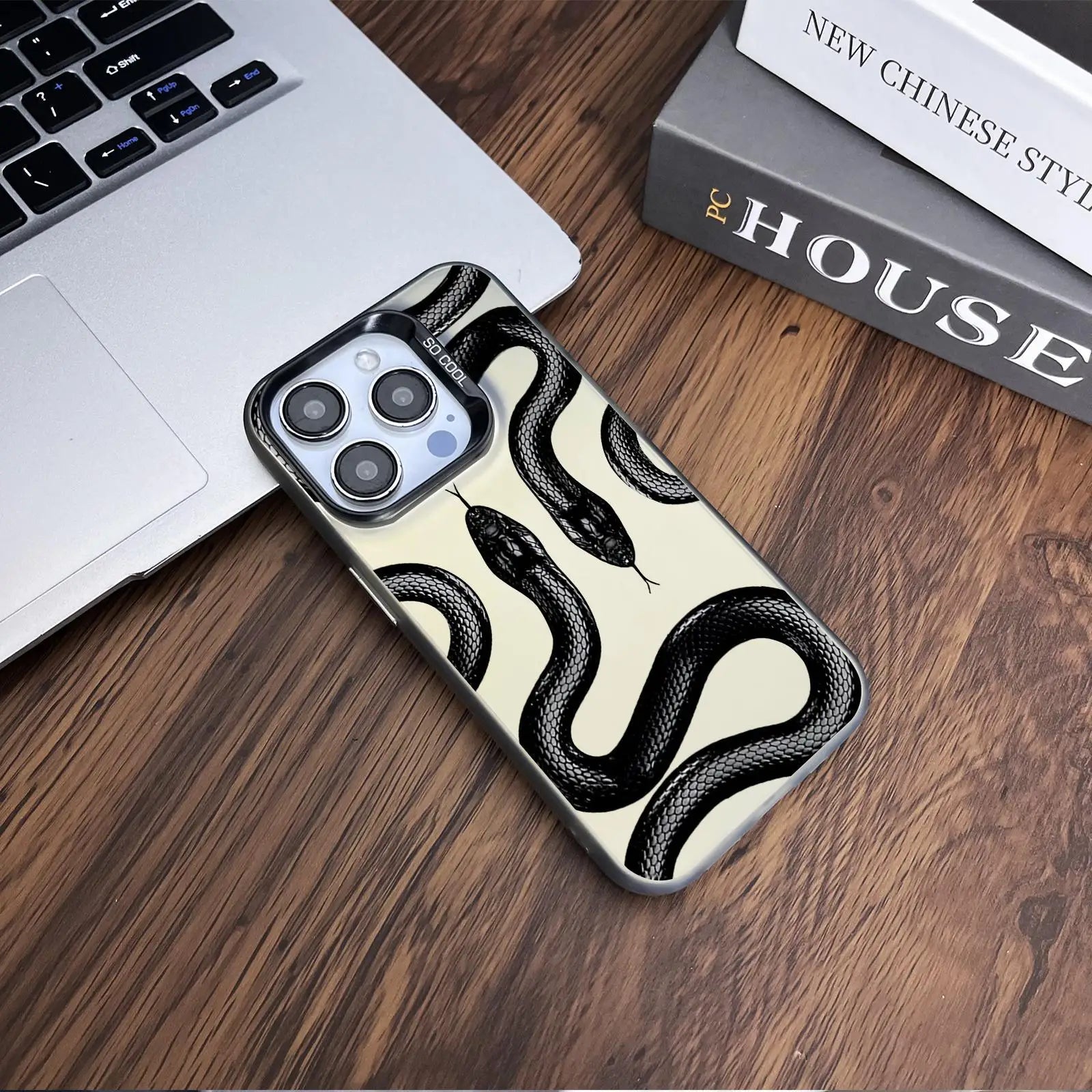 Snake pattern anti-drop phone case for iPhone 12 to 16 Pro on table.