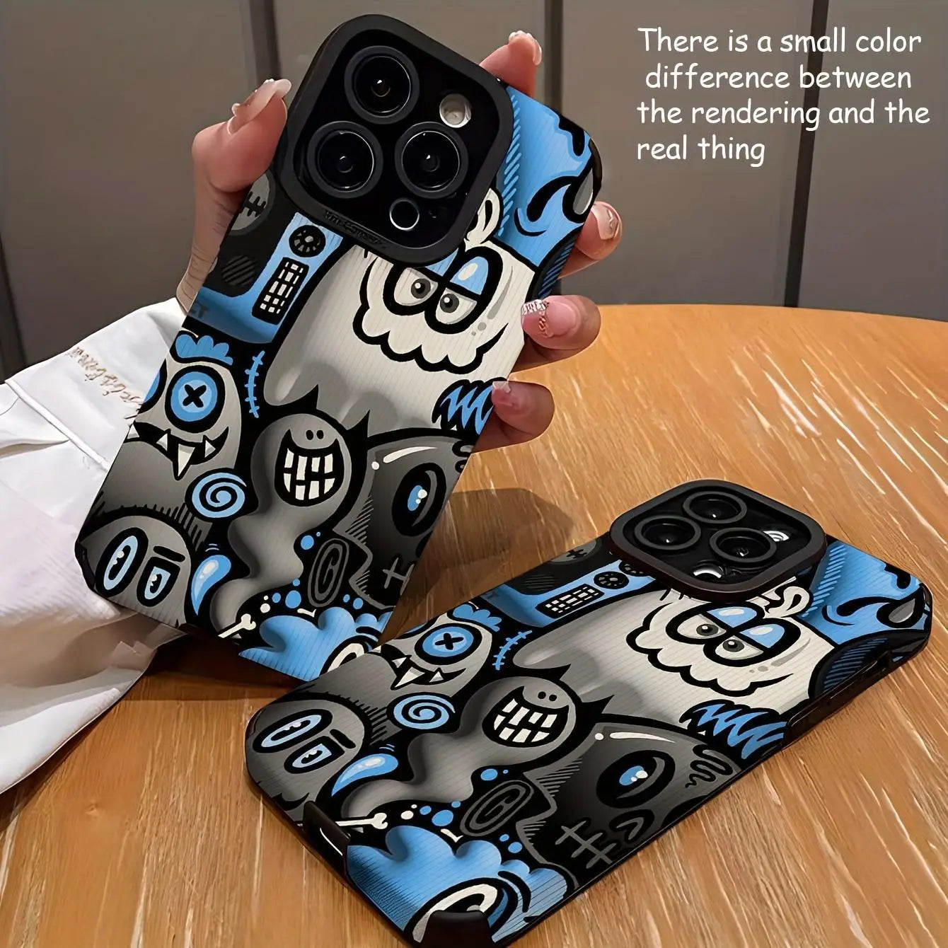 Cartoon graffiti phone case for iPhone 16 Pro Max to 11, blue and black design, on table.